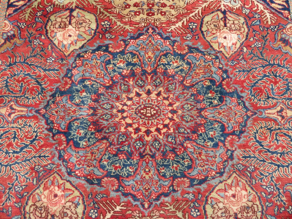 An antique hand-knotted North West Persian Tabriz rug featuring a central floral medallion surrounded by detailed terracotta red, navy blue, and cream motifs. View IV