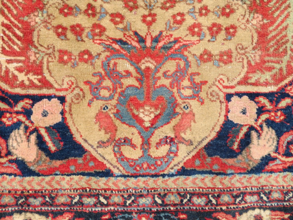 An antique hand-knotted North West Persian Tabriz rug featuring a central floral medallion surrounded by detailed terracotta red, navy blue, and cream motifs. View V