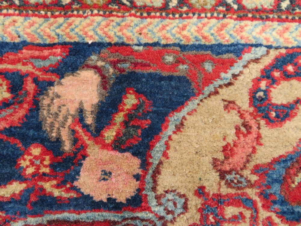An antique hand-knotted North West Persian Tabriz rug featuring a central floral medallion surrounded by detailed terracotta red, navy blue, and cream motifs. View VII