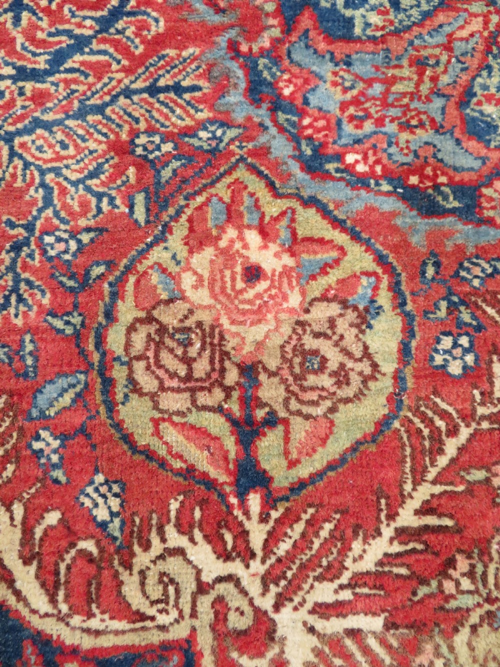 An antique hand-knotted North West Persian Tabriz rug featuring a central floral medallion surrounded by detailed terracotta red, navy blue, and cream motifs. View X