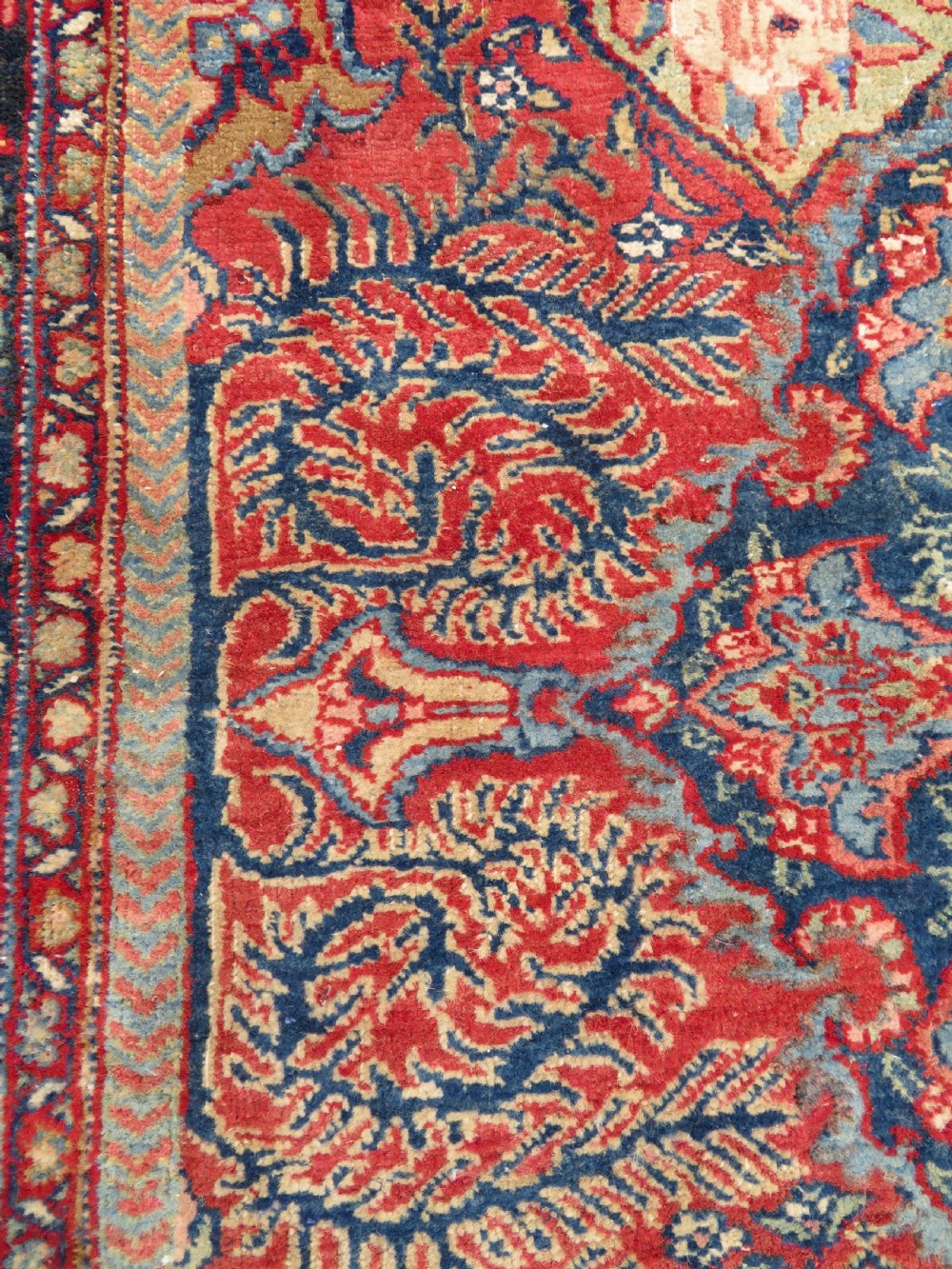 An antique hand-knotted North West Persian Tabriz rug featuring a central floral medallion surrounded by detailed terracotta red, navy blue, and cream motifs. View XI