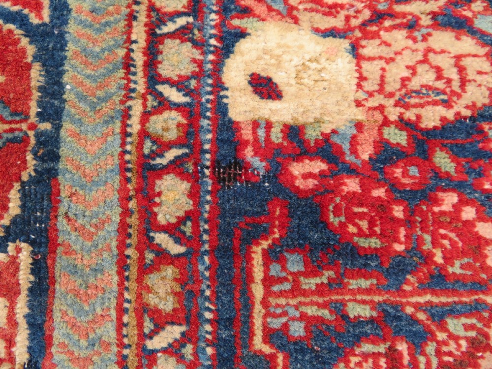 An antique hand-knotted North West Persian Tabriz rug featuring a central floral medallion surrounded by detailed terracotta red, navy blue, and cream motifs. View XIV