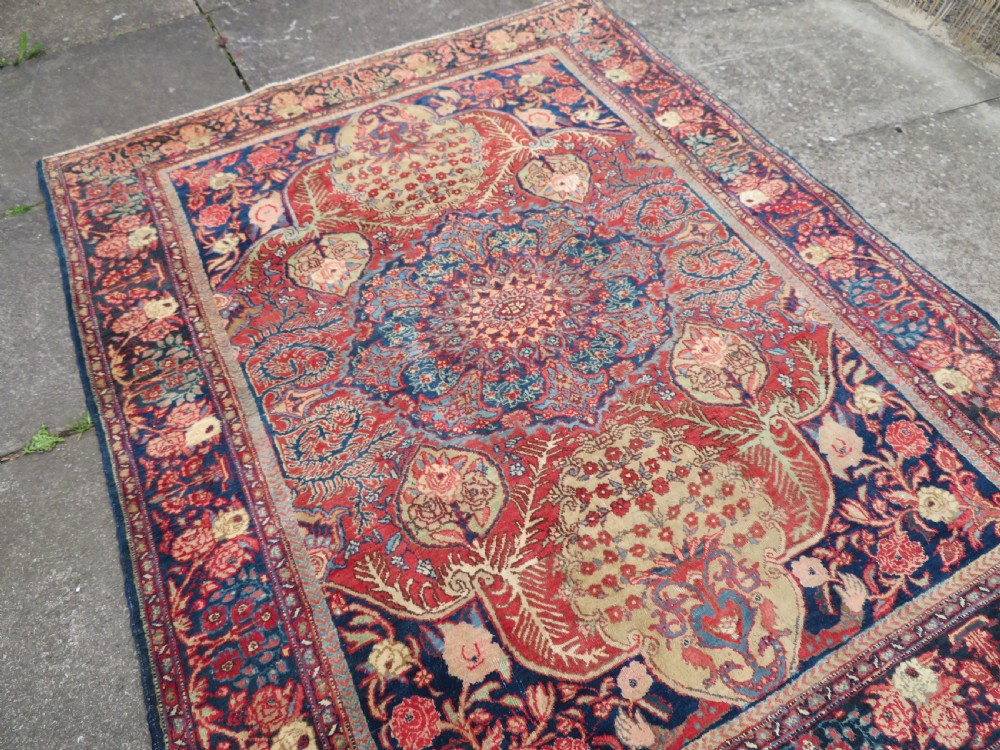 An antique hand-knotted North West Persian Tabriz rug featuring a central floral medallion surrounded by detailed terracotta red, navy blue, and cream motifs. View XVII