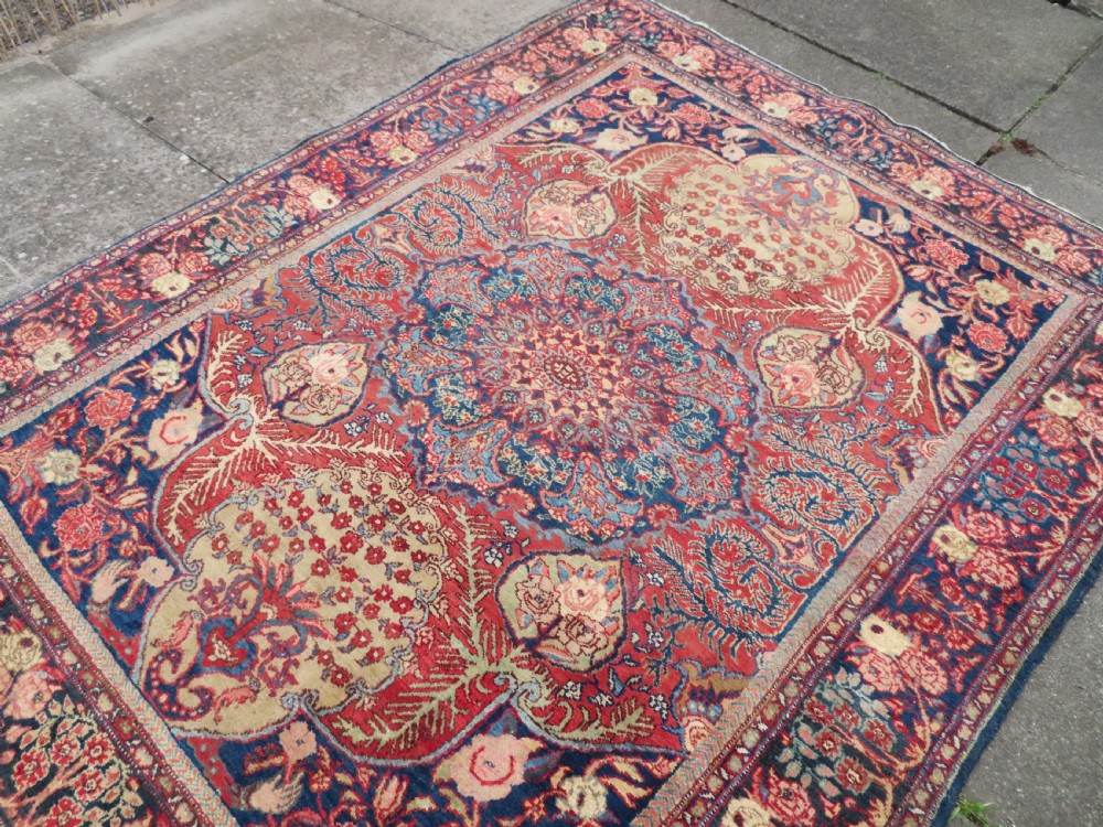 An antique hand-knotted North West Persian Tabriz rug featuring a central floral medallion surrounded by detailed terracotta red, navy blue, and cream motifs. View XVIII
