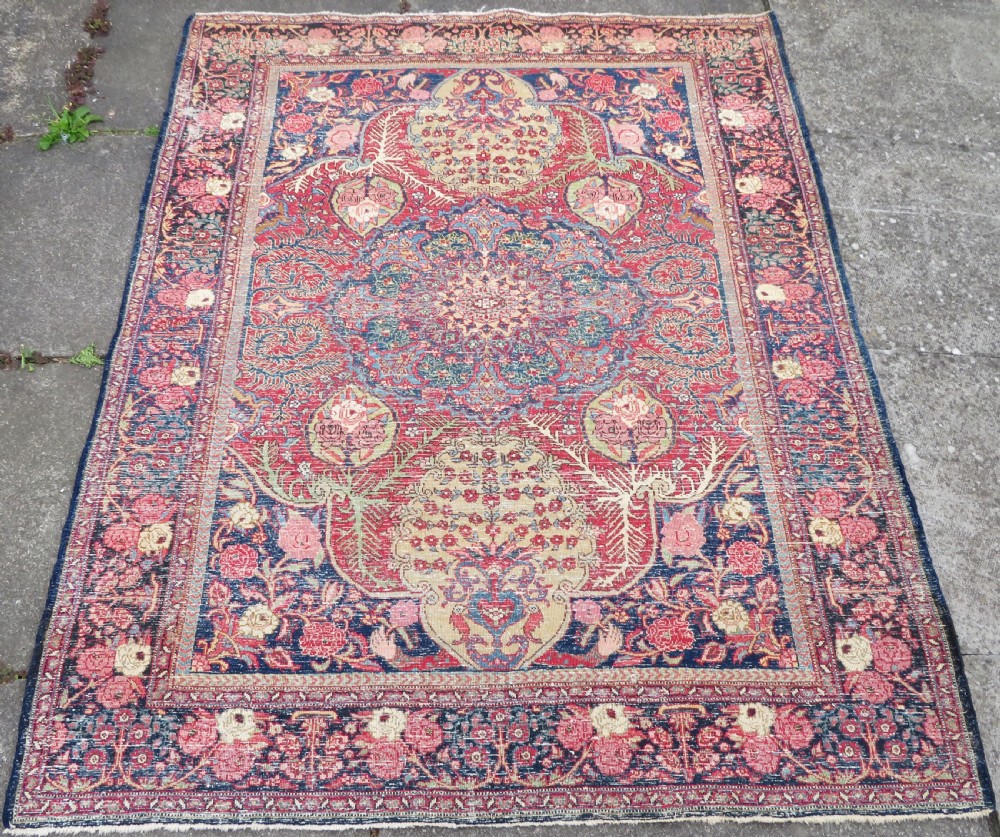An antique hand-knotted North West Persian Tabriz rug featuring a central floral medallion surrounded by detailed terracotta red, navy blue, and cream motifs. View XIX