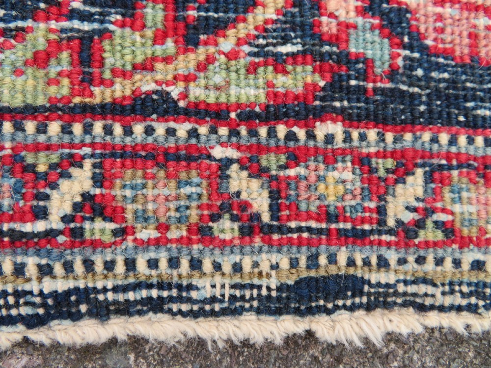 An antique hand-knotted North West Persian Tabriz rug featuring a central floral medallion surrounded by detailed terracotta red, navy blue, and cream motifs. View XXI