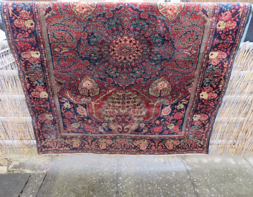 An antique hand-knotted North West Persian Tabriz rug featuring a central floral medallion surrounded by detailed terracotta red, navy blue, and cream motifs. View XXIX