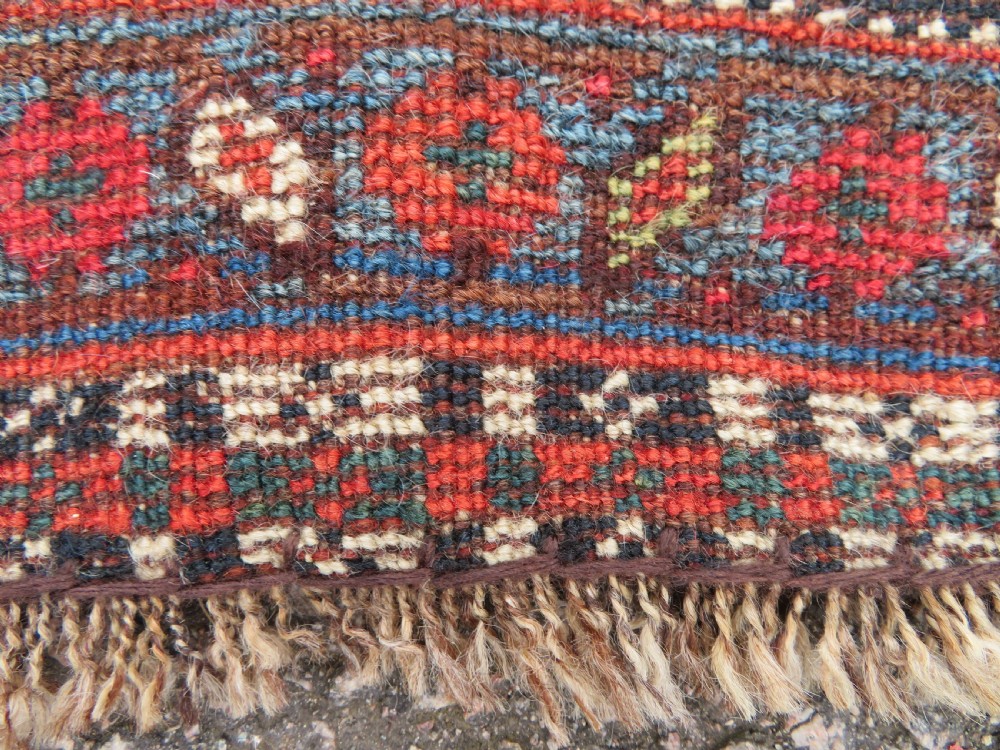 An antique hand-knotted South Persian Khamseh rug featuring a central diamond medallion surrounded by a striped field and geometric borders in shades of terracotta red, navy blue, and cream. View XXV