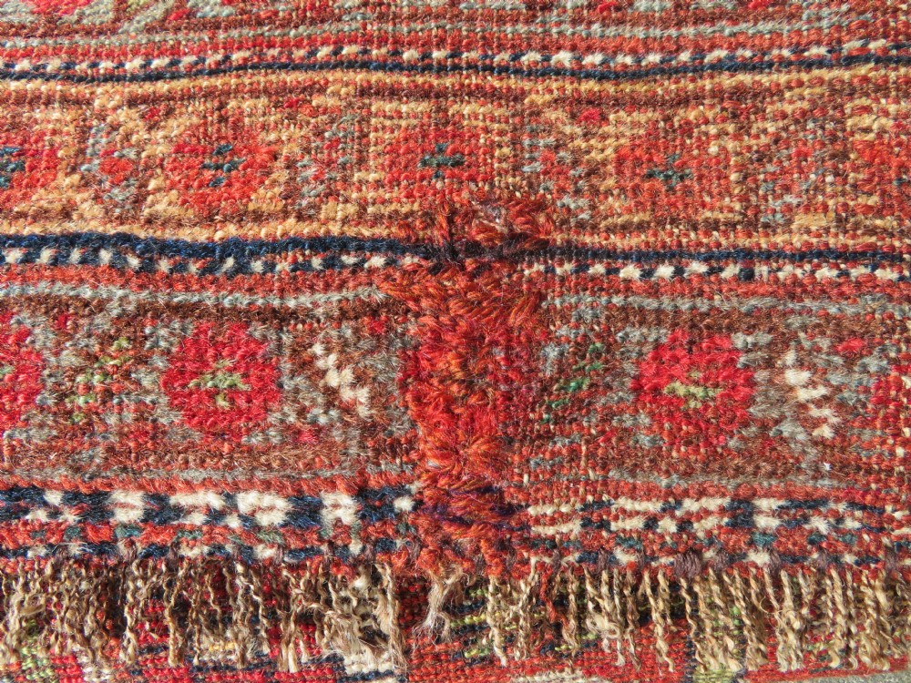 An antique hand-knotted South Persian Khamseh rug featuring a central diamond medallion surrounded by a striped field and geometric borders in shades of terracotta red, navy blue, and cream. View XXVII