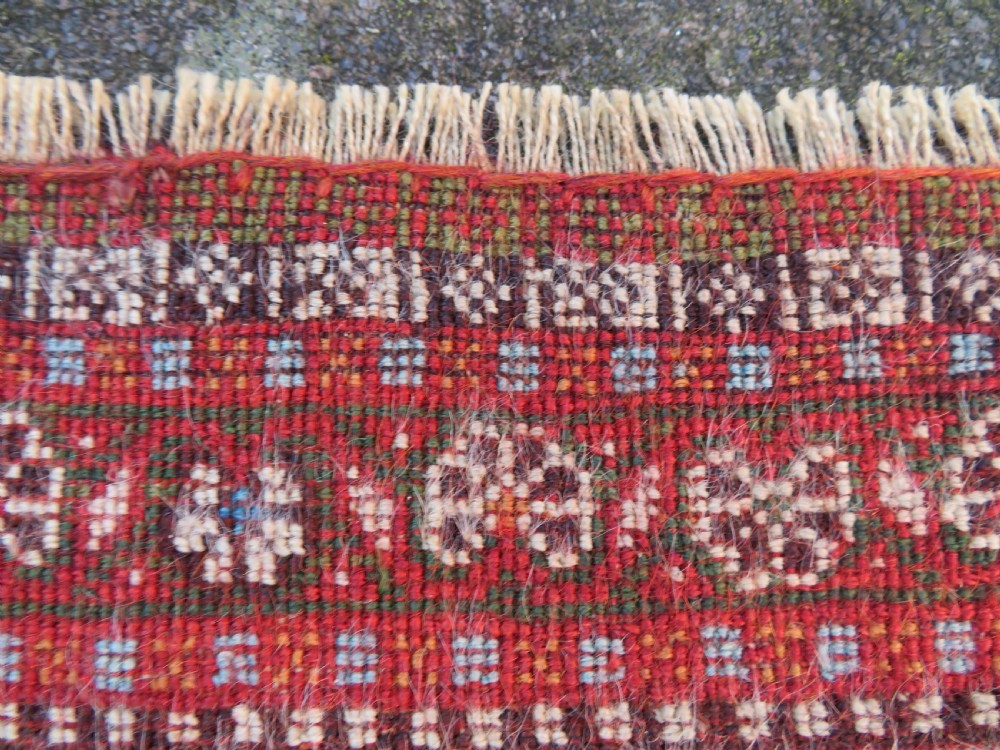 An antique Persian Qashqai Kashkuli wool rug featuring repeating boteh patterns on a deep indigo blue field surrounded by intricate cream and terracotta floral borders. View XXIV