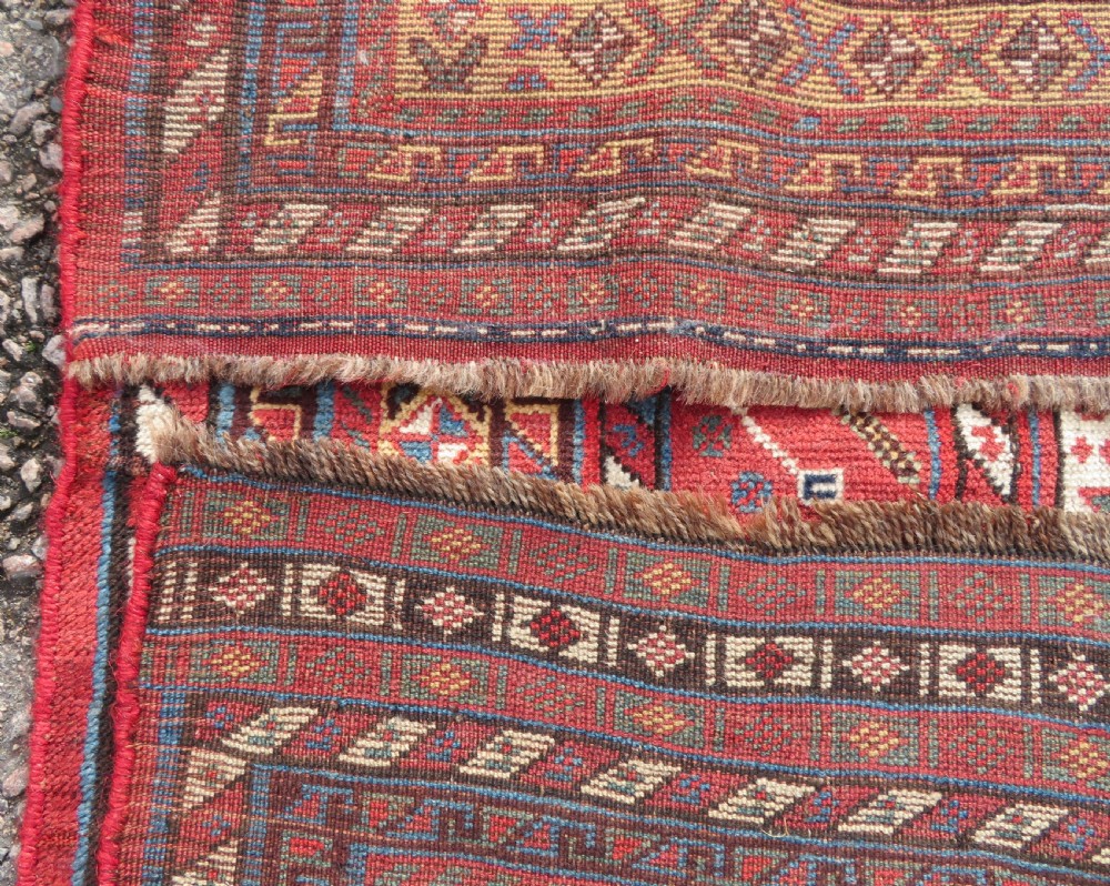 A late 19th-century Persian Qashqai hand-knotted wool rug featuring a navy blue field filled with stylized red peacock motifs, a central cream diamond medallion, and a wide red geometric border. View XXVII