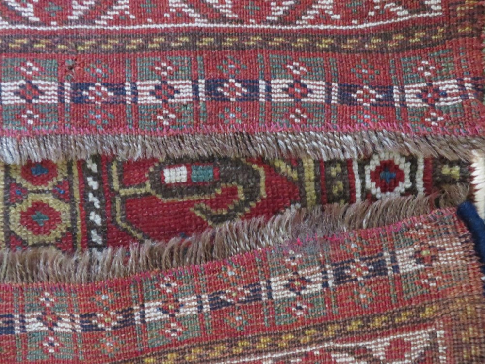 An antique hand-woven Persian Khamseh wool rug featuring a central geometric medallion with tribal bird motifs in red, navy blue, and ivory tones. View XXII