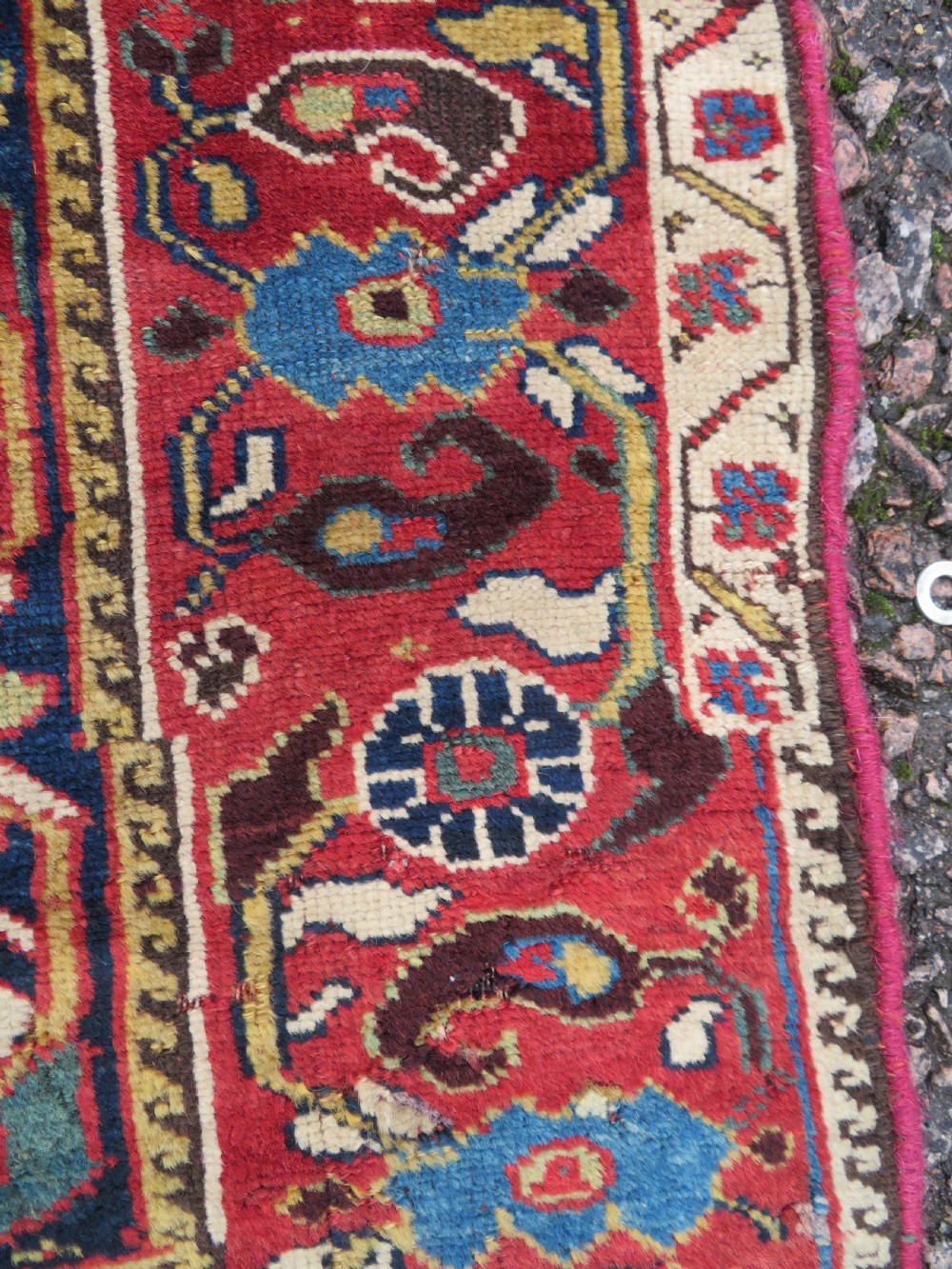A long hand-knotted Persian Khamseh rug with a navy blue field filled with repeating floral and boteh motifs, framed by a patterned red border. View VIII