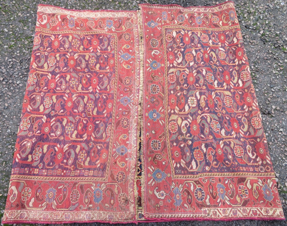 A long hand-knotted Persian Khamseh rug with a navy blue field filled with repeating floral and boteh motifs, framed by a patterned red border. View XX