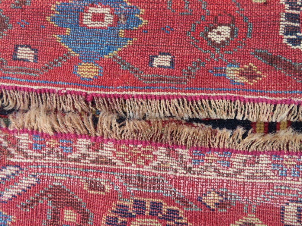 A long hand-knotted Persian Khamseh rug with a navy blue field filled with repeating floral and boteh motifs, framed by a patterned red border. View XXI