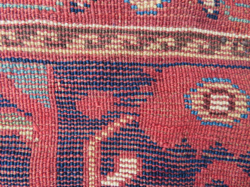 A long hand-knotted Persian Khamseh rug with a navy blue field filled with repeating floral and boteh motifs, framed by a patterned red border. View XXII