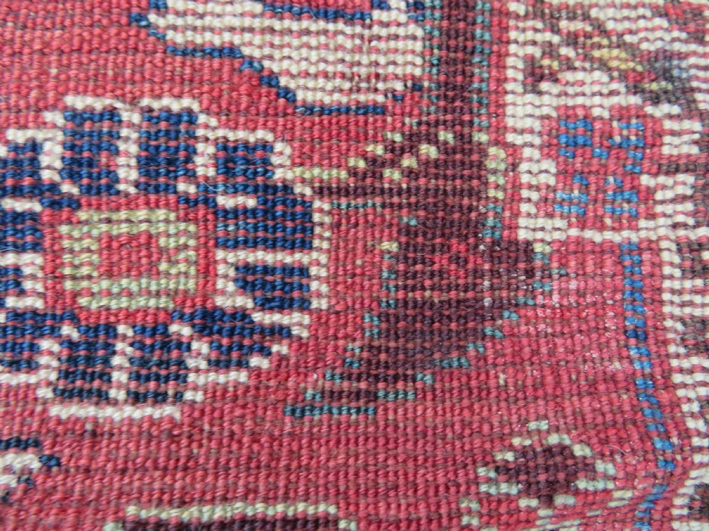 A long hand-knotted Persian Khamseh rug with a navy blue field filled with repeating floral and boteh motifs, framed by a patterned red border. View XXIII