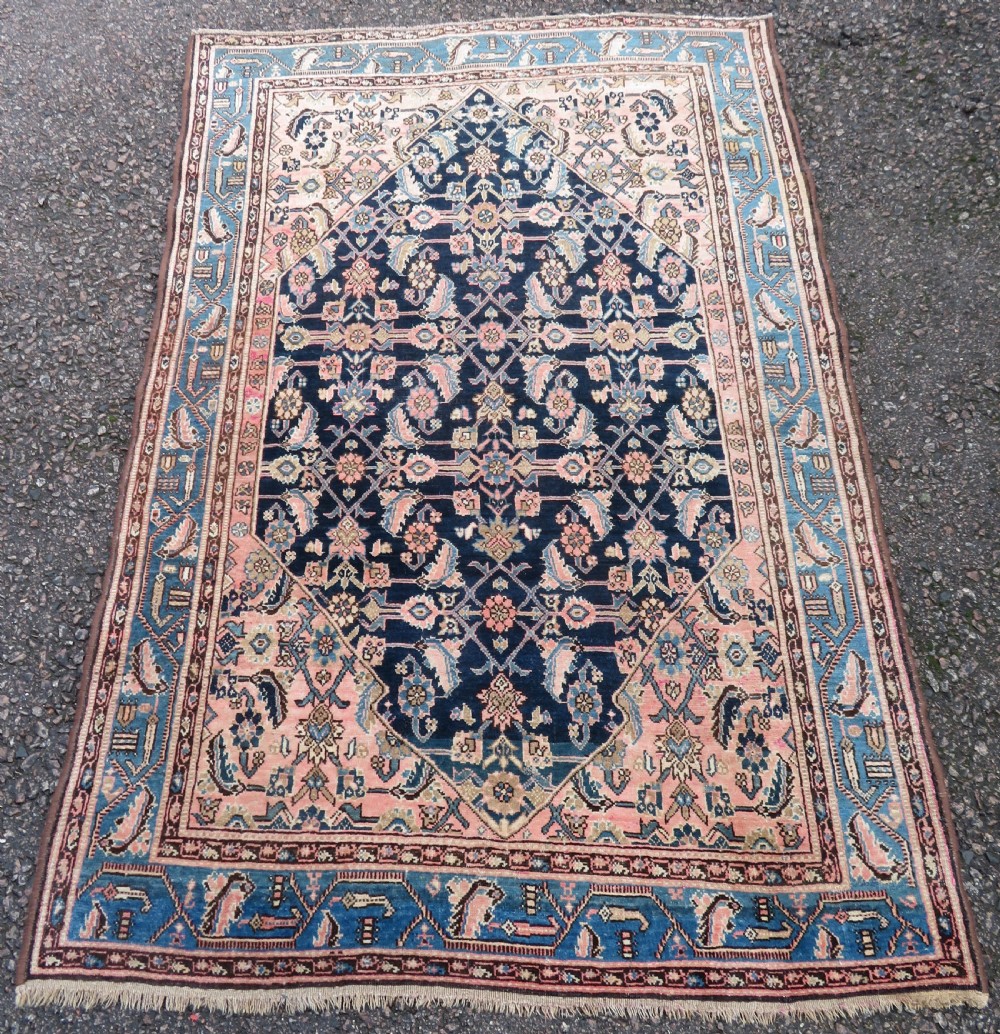 A hand-knotted Bidjar Persian rug featuring a navy blue diamond medallion, salmon pink spandrels, and multi-layered blue floral borders. View II