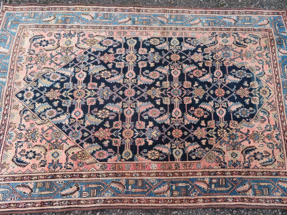 A hand-knotted Bidjar Persian rug featuring a navy blue diamond medallion, salmon pink spandrels, and multi-layered blue floral borders. View III