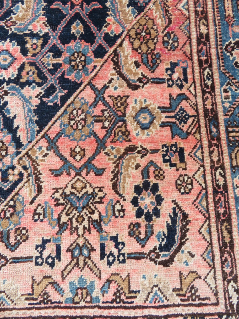 A hand-knotted Bidjar Persian rug featuring a navy blue diamond medallion, salmon pink spandrels, and multi-layered blue floral borders. View VII