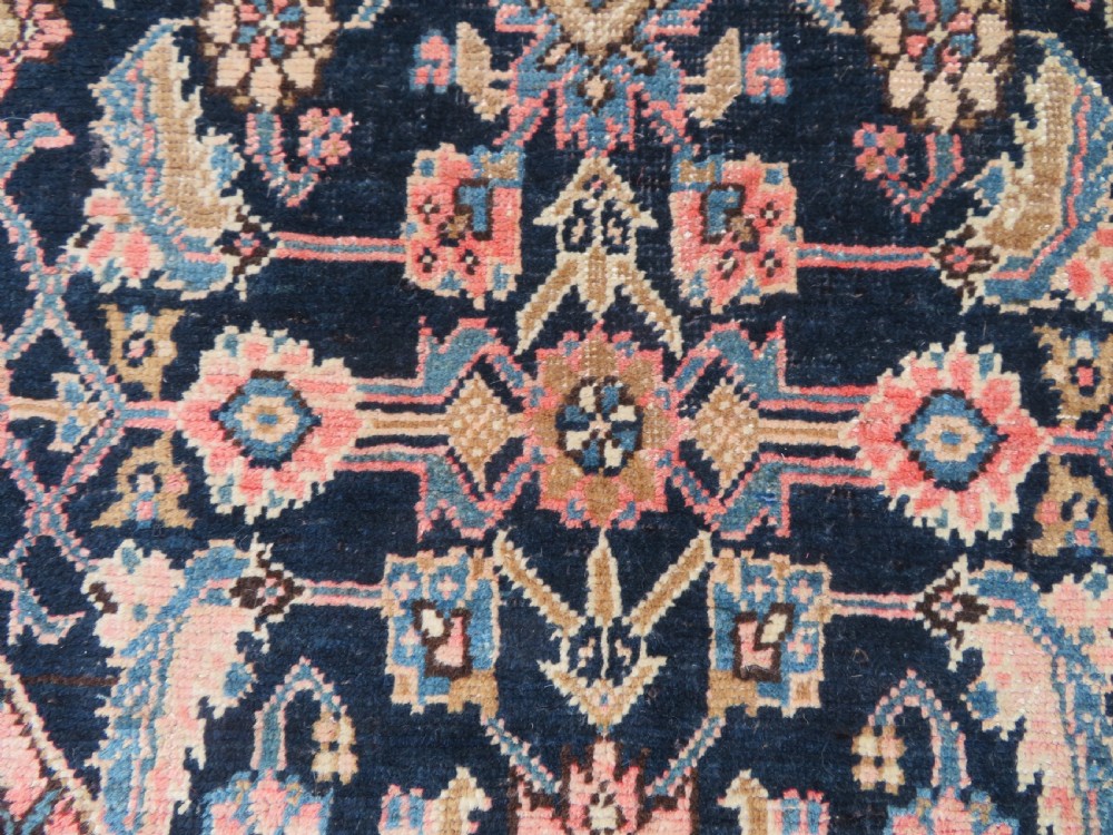 A hand-knotted Bidjar Persian rug featuring a navy blue diamond medallion, salmon pink spandrels, and multi-layered blue floral borders. View IX