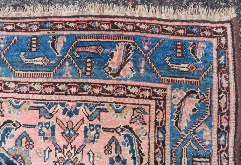 A hand-knotted Bidjar Persian rug featuring a navy blue diamond medallion, salmon pink spandrels, and multi-layered blue floral borders. View XI