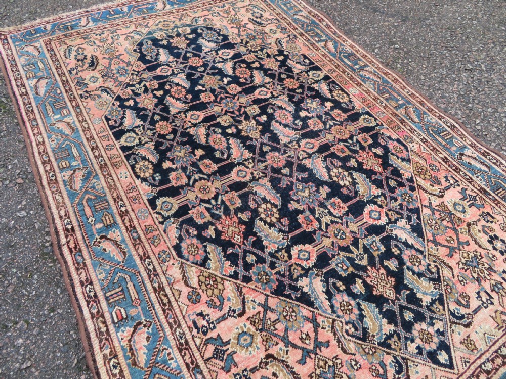 A hand-knotted Bidjar Persian rug featuring a navy blue diamond medallion, salmon pink spandrels, and multi-layered blue floral borders. View XII