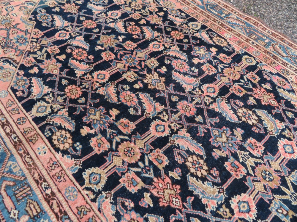 A hand-knotted Bidjar Persian rug featuring a navy blue diamond medallion, salmon pink spandrels, and multi-layered blue floral borders. View XIV
