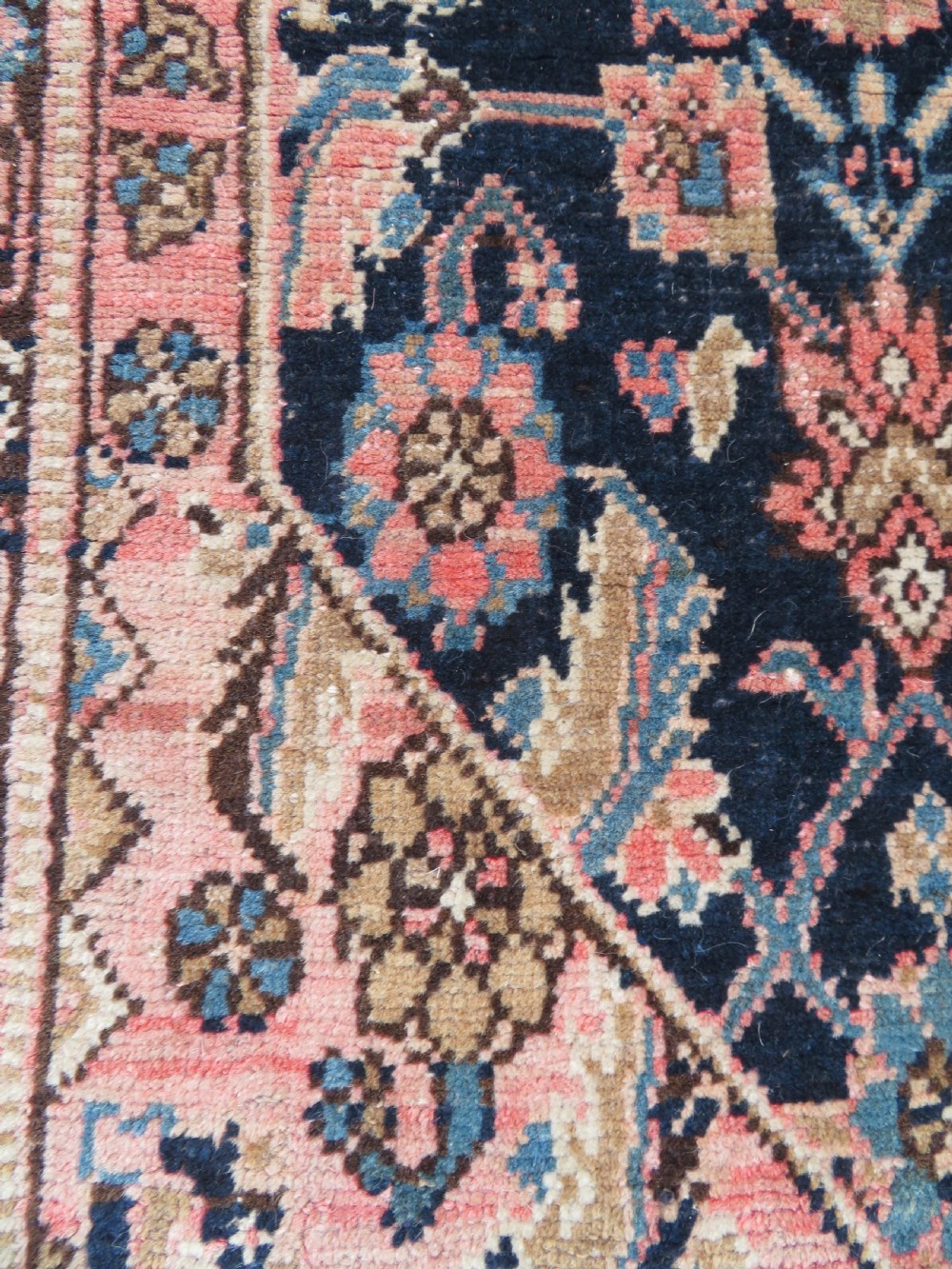 A hand-knotted Bidjar Persian rug featuring a navy blue diamond medallion, salmon pink spandrels, and multi-layered blue floral borders. View XV