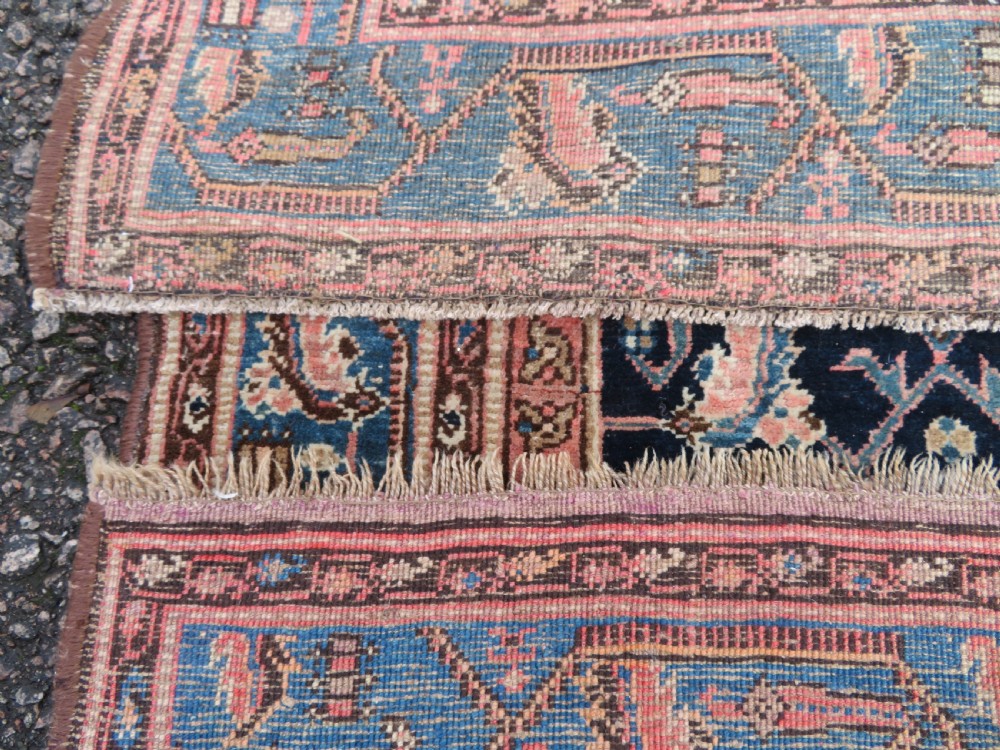 A hand-knotted Bidjar Persian rug featuring a navy blue diamond medallion, salmon pink spandrels, and multi-layered blue floral borders. View XVII