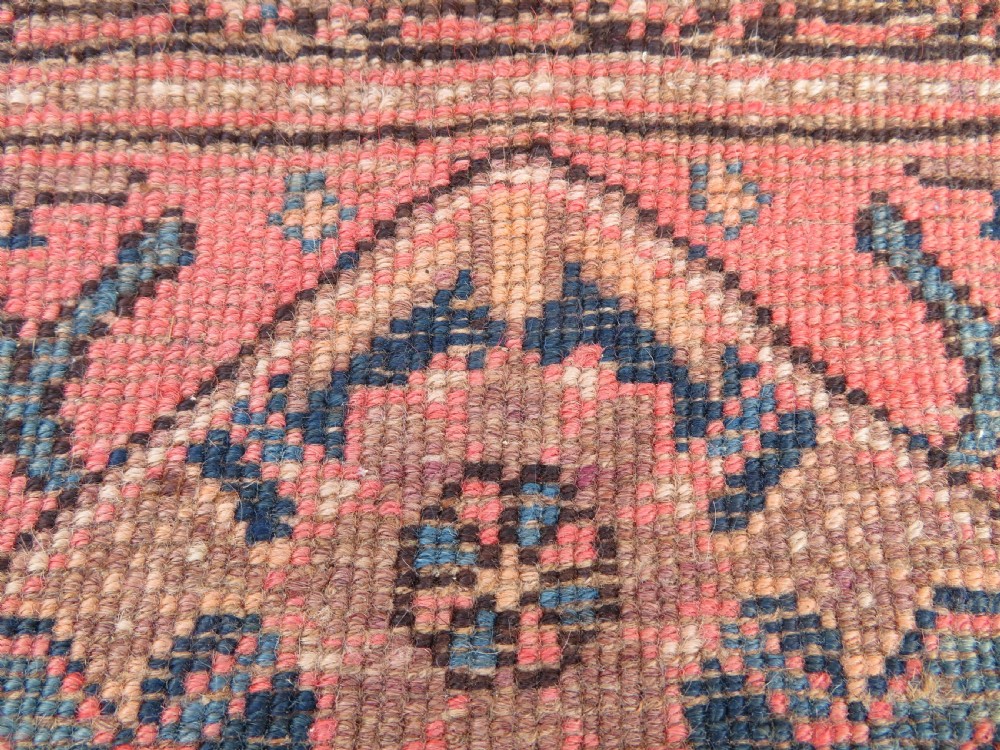 A hand-knotted Bidjar Persian rug featuring a navy blue diamond medallion, salmon pink spandrels, and multi-layered blue floral borders. View XVIII