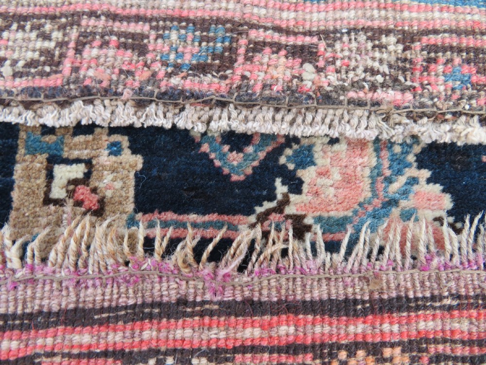 A hand-knotted Bidjar Persian rug featuring a navy blue diamond medallion, salmon pink spandrels, and multi-layered blue floral borders. View XIX