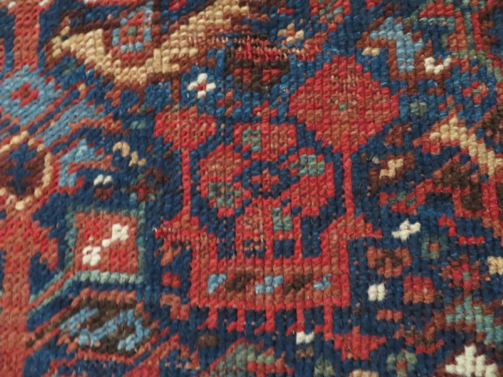 An antique hand-knotted Persian Khamseh rug featuring three diamond central medallions and bird motifs in deep red, navy, cream, and terracotta tones. View XI