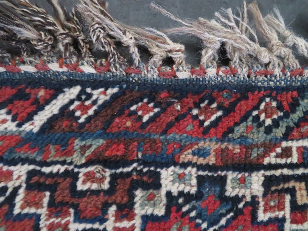 An antique hand-knotted Persian Khamseh rug featuring three diamond central medallions and bird motifs in deep red, navy, cream, and terracotta tones. View XIV