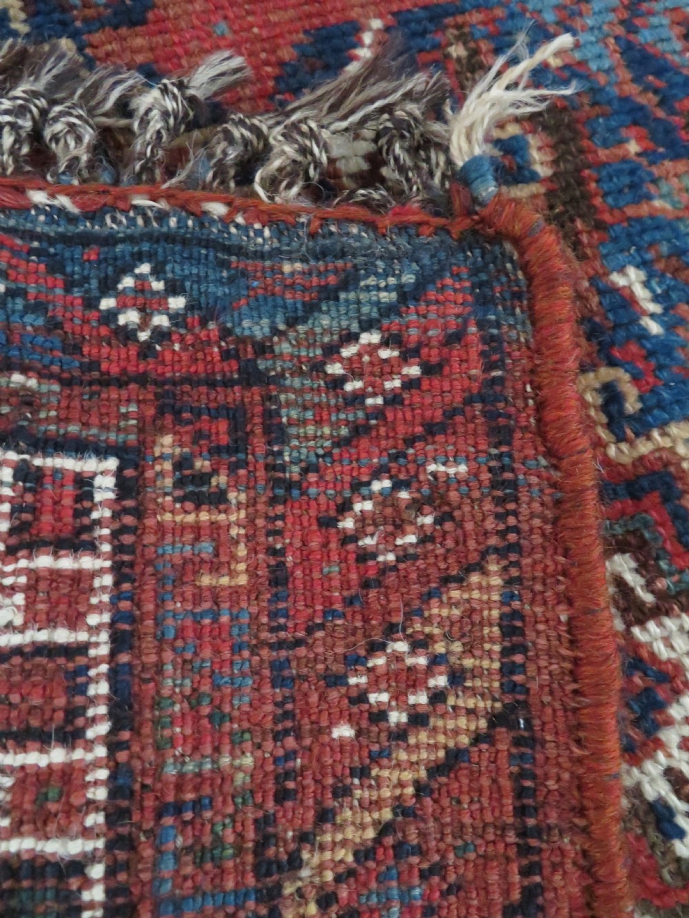 An antique hand-knotted Persian Khamseh rug featuring three diamond central medallions and bird motifs in deep red, navy, cream, and terracotta tones. View XVI