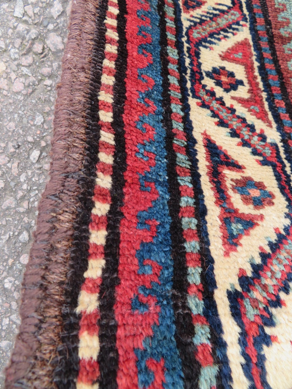 An antique hand-knotted Quchan Kurdish wool rug displaying a central diamond pattern inside a dark red and navy lattice grid with geometric borders. View VI