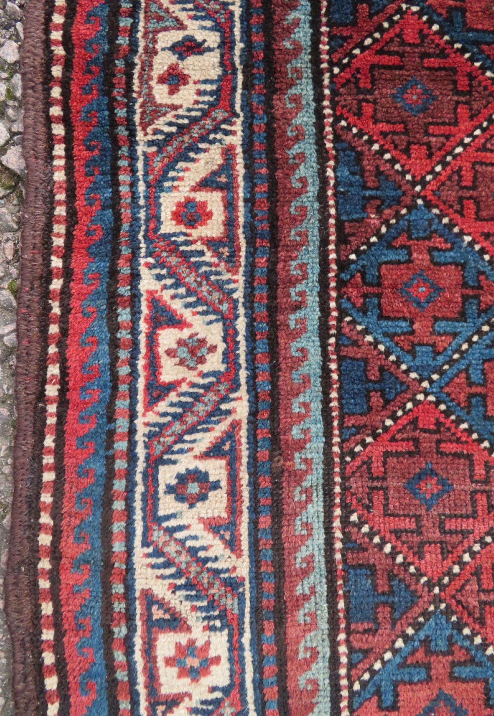 An antique hand-knotted Quchan Kurdish wool rug displaying a central diamond pattern inside a dark red and navy lattice grid with geometric borders. View XI