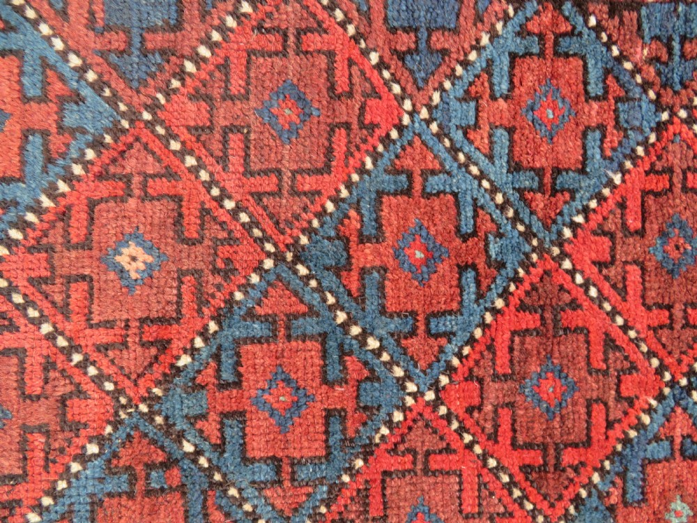 An antique hand-knotted Quchan Kurdish wool rug displaying a central diamond pattern inside a dark red and navy lattice grid with geometric borders. View XIV
