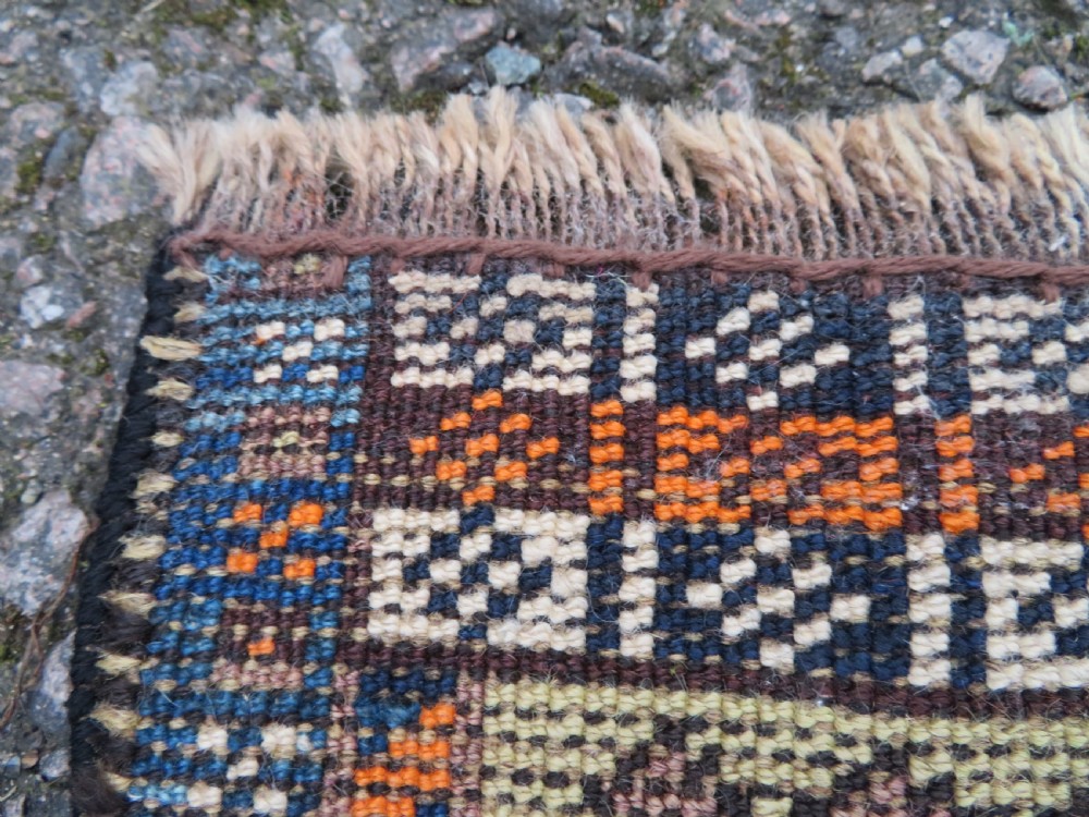 A handwoven Luri tribal rug featuring double geometric diamond medallions in navy blue and red with multi-layered patterned borders. View XXI
