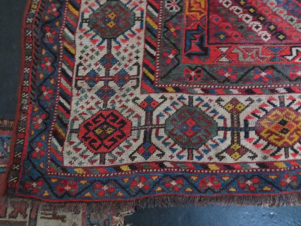 An antique hand-knotted Qashqai wool rug featuring three diamond central medallions with tribal peacock motifs in red, blue, and magenta tones. View XXIII