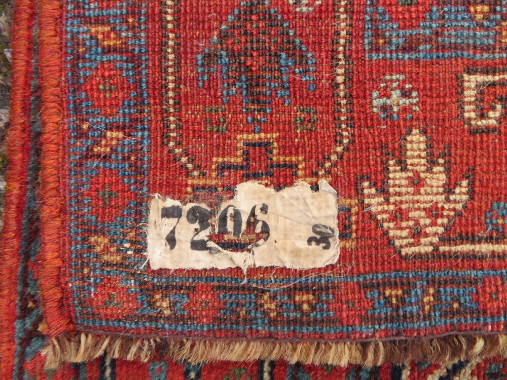A nineteenth-century hand-knotted Khamseh tribal carpet featuring three diamond-shaped central medallions on an indigo blue field surrounded by geometric borders. View XX