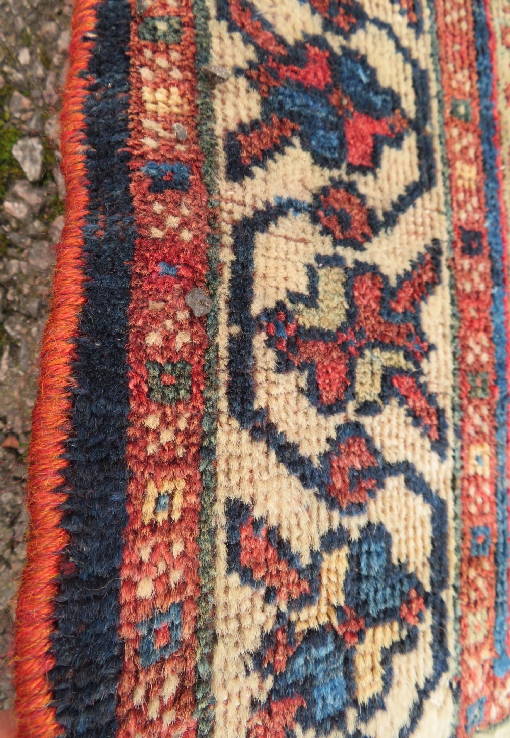 An antique hand-knotted Persian tribal rug featuring three central diamond-shaped medallions, geometric peacock motifs, and multi-layered borders in navy blue, red, and ivory wool. View VI