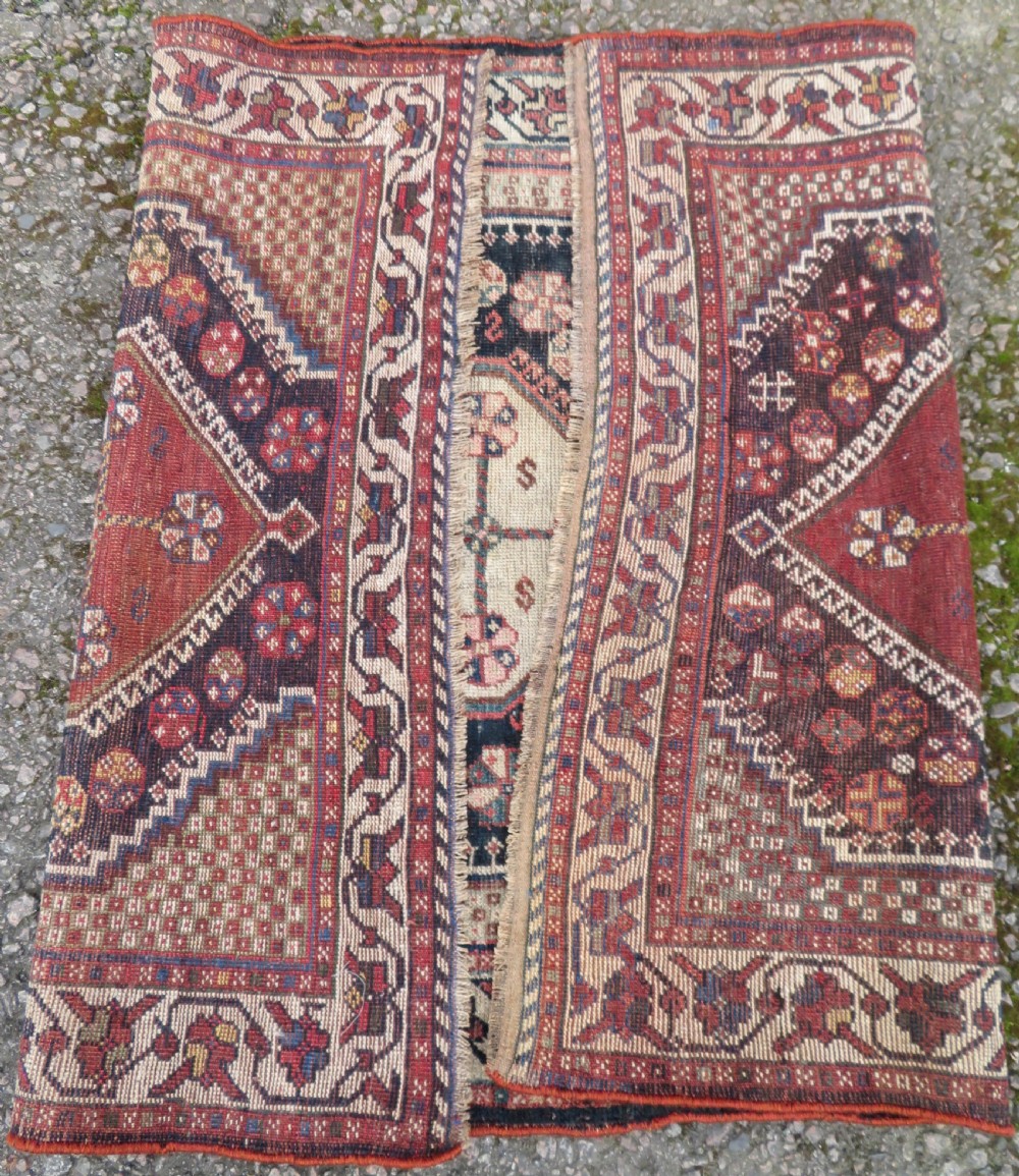 An antique hand-knotted Persian tribal rug featuring three central diamond-shaped medallions, geometric peacock motifs, and multi-layered borders in navy blue, red, and ivory wool. View IX
