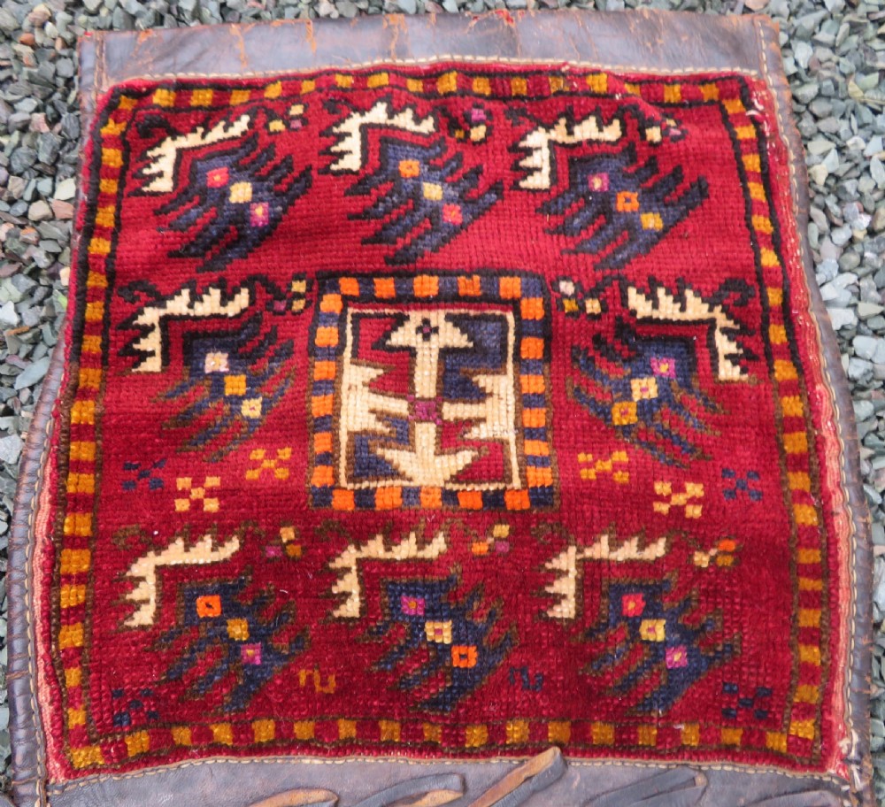 A late 19th-century Eastern Anatolian Yuruk double saddlebag woven in red, navy, and orange geometric wool patterns with leather binding. View IV