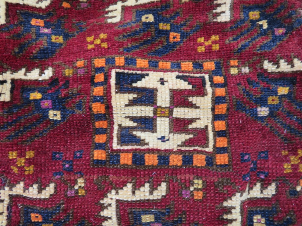 A late 19th-century Eastern Anatolian Yuruk double saddlebag woven in red, navy, and orange geometric wool patterns with leather binding. View IX