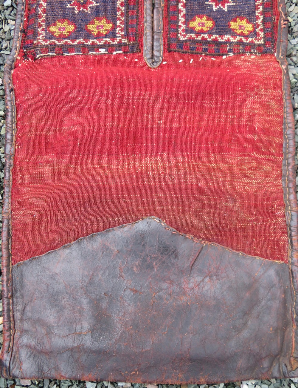 A late 19th-century Eastern Anatolian Yuruk double saddlebag woven in red, navy, and orange geometric wool patterns with leather binding. View XII
