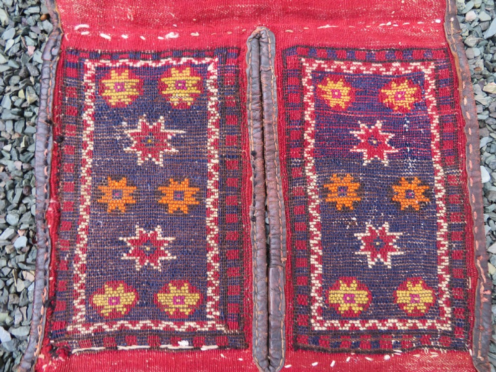 A late 19th-century Eastern Anatolian Yuruk double saddlebag woven in red, navy, and orange geometric wool patterns with leather binding. View XIII