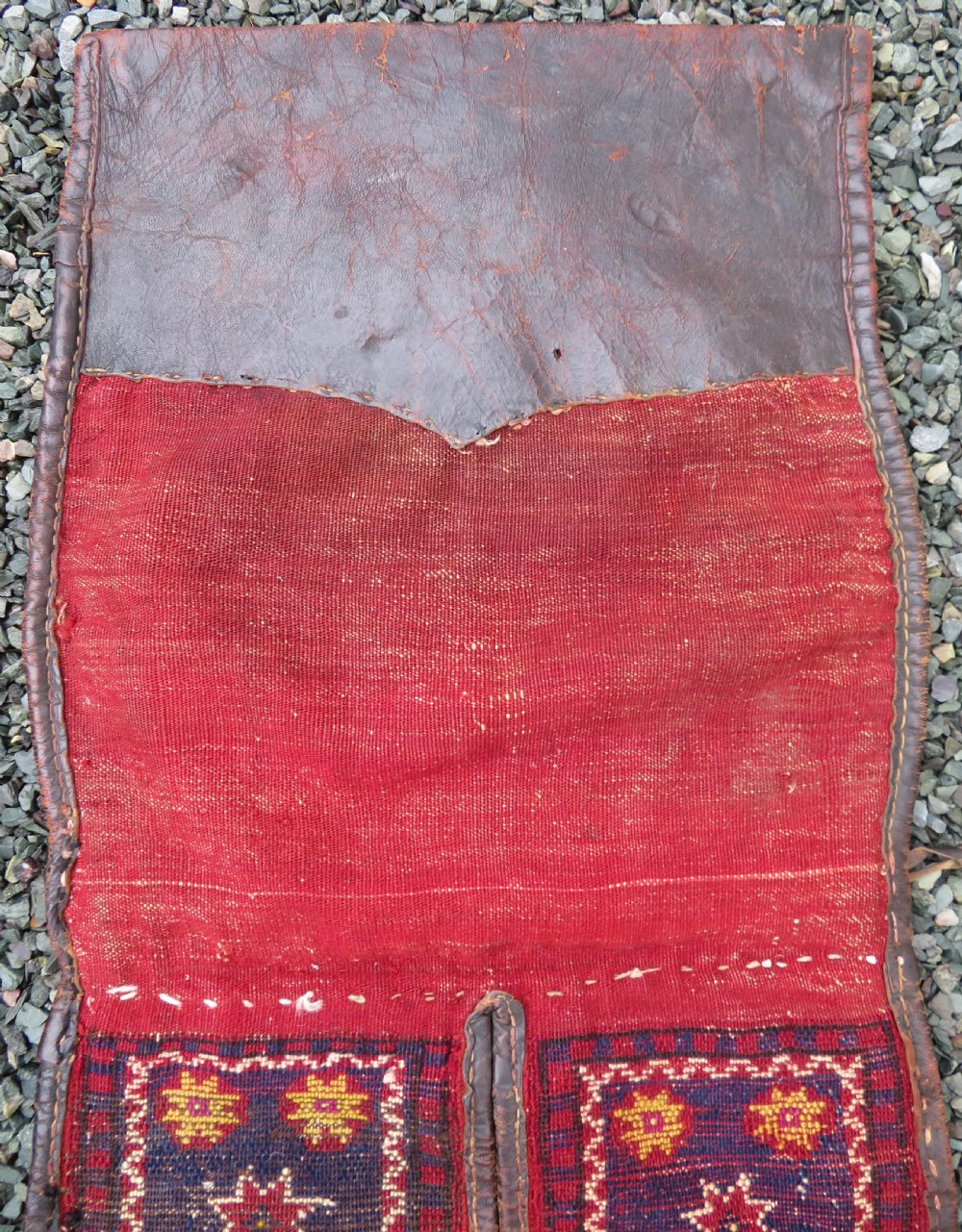 A late 19th-century Eastern Anatolian Yuruk double saddlebag woven in red, navy, and orange geometric wool patterns with leather binding. View XV