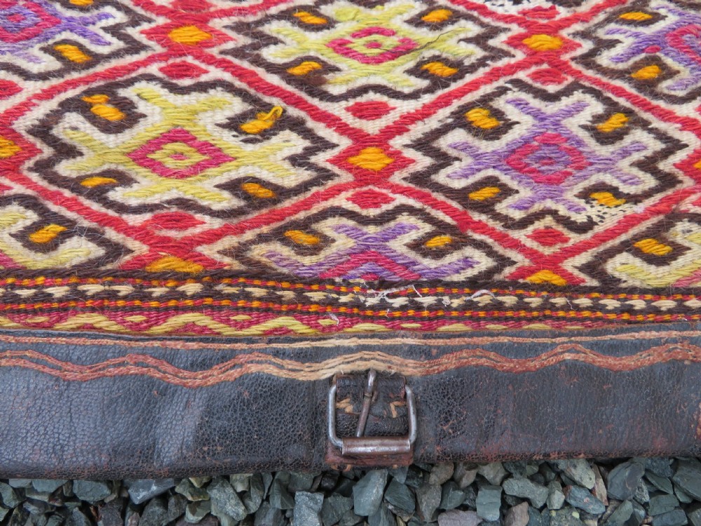 A late 19th-century Shahsavan Persian double saddle bag featuring dark leather flaps and central multi-coloured striped wool flatweave panels. View IV
