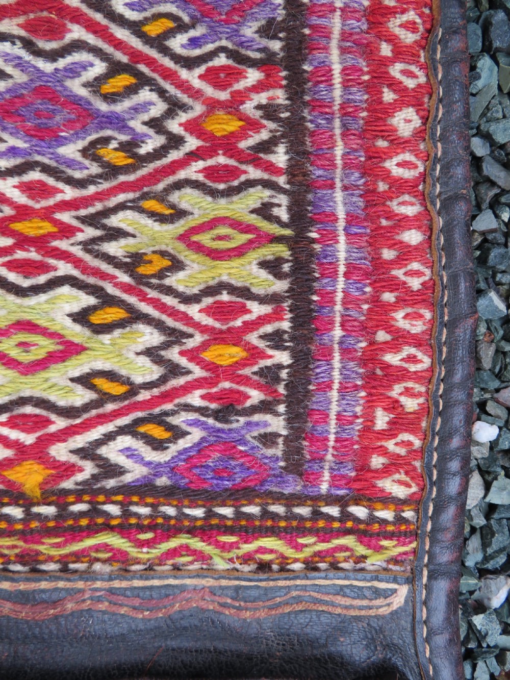 A late 19th-century Shahsavan Persian double saddle bag featuring dark leather flaps and central multi-coloured striped wool flatweave panels. View VI